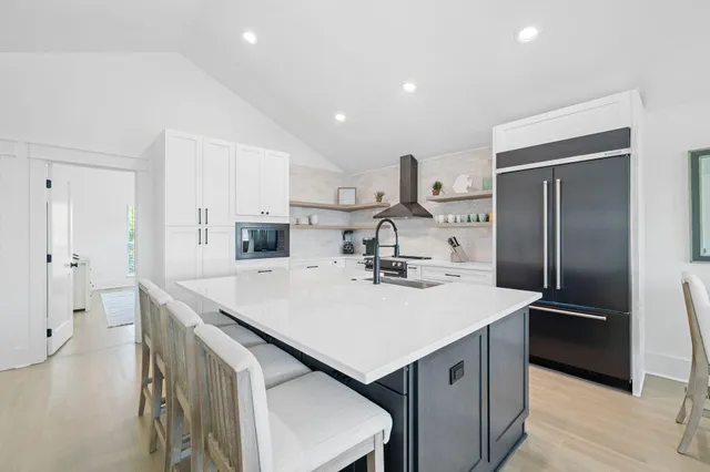 a kitchen with a sink a counter top space stainless steel appliances and cabinets