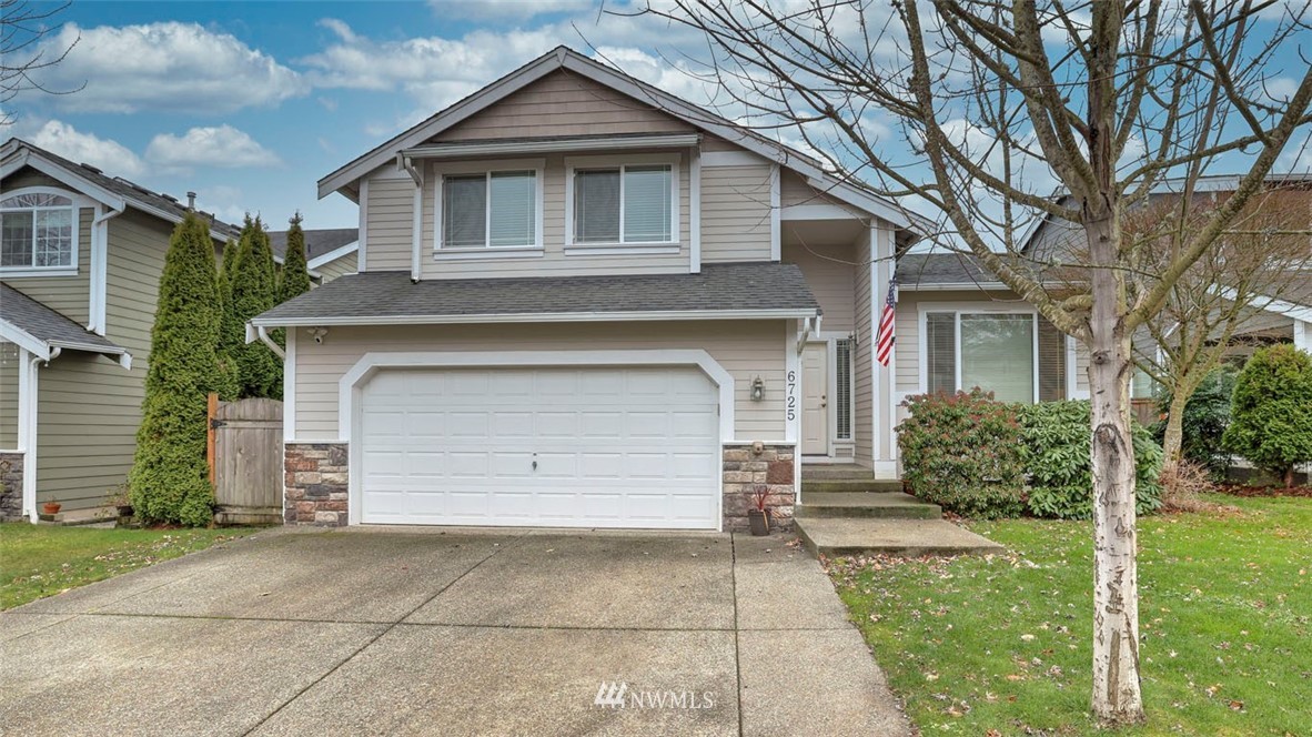 6725 Southeast 3rd Street Renton, WA 98059 - Photo 1 of 32 a front view of a house with a yard and garage
