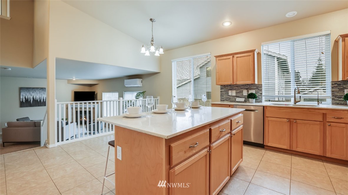 6725 Southeast 3rd Street Renton, WA 98059 - Photo 11 of 32 a kitchen with stainless steel appliances granite countertop a sink and cabinets