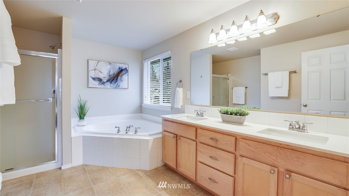 6725 Southeast 3rd Street Renton, WA 98059 - Photo 16 of 32 a bathroom with a sink a vanity and a mirror