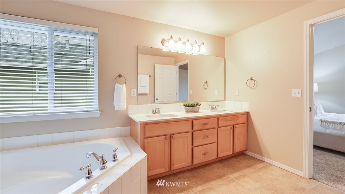 6725 Southeast 3rd Street Renton, WA 98059 - Photo 17 of 32 a bathroom with a tub sink and mirror