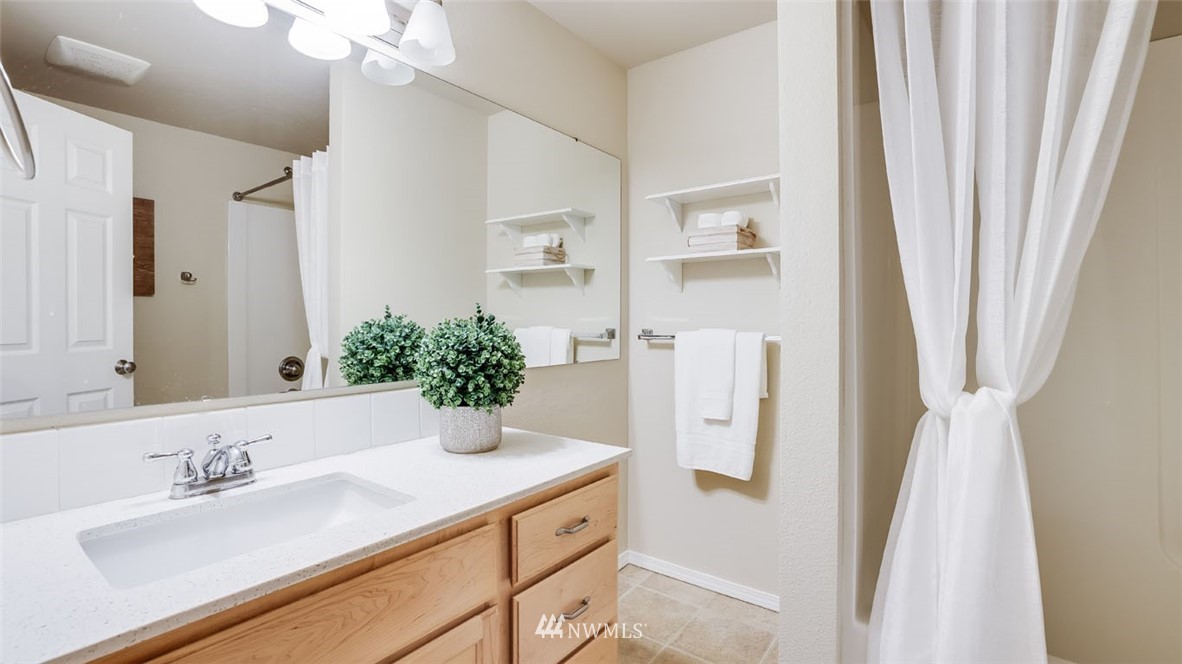 6725 Southeast 3rd Street Renton, WA 98059 - Photo 20 of 32 a bathroom with a granite countertop sink and a mirror