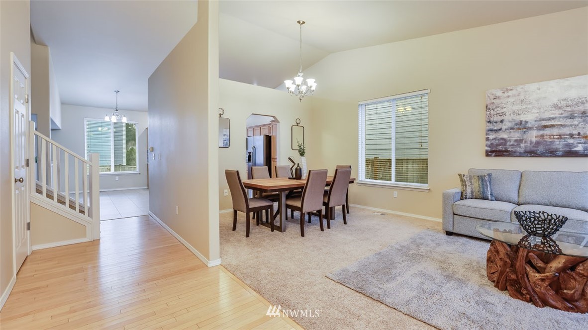 6725 Southeast 3rd Street Renton, WA 98059 - Photo 3 of 32 a view of a a dining room with furniture window and wooden floor