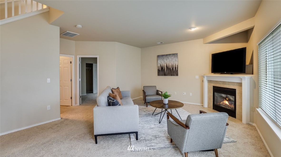 6725 Southeast 3rd Street Renton, WA 98059 - Photo 24 of 32 a living room with furniture a fireplace and a flat screen tv