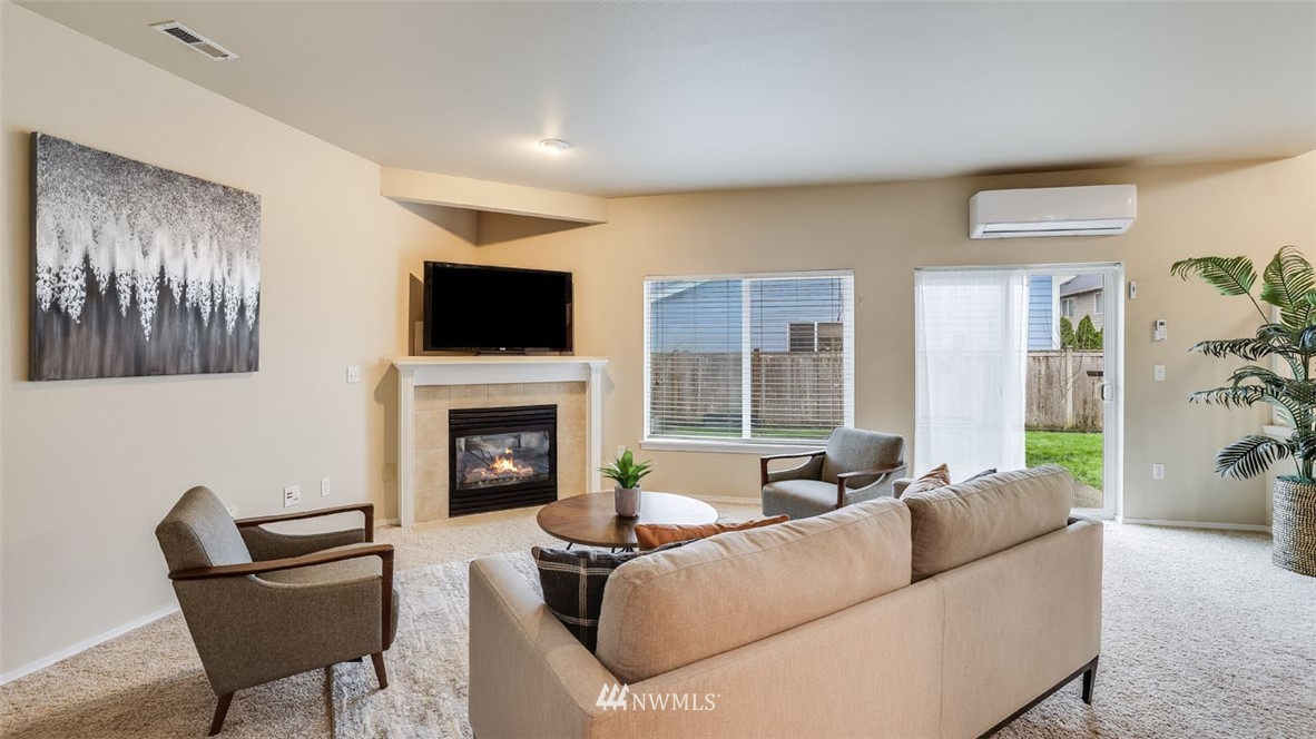 6725 Southeast 3rd Street Renton, WA 98059 - Photo 25 of 32 a living room with furniture a fireplace and a flat screen tv