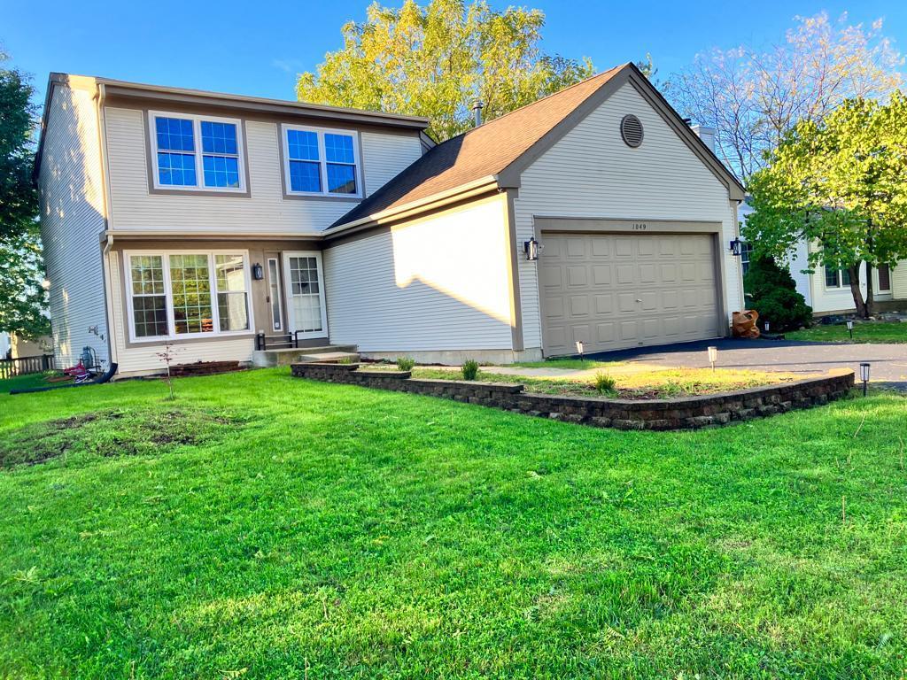 a view of a house with pool and a yard