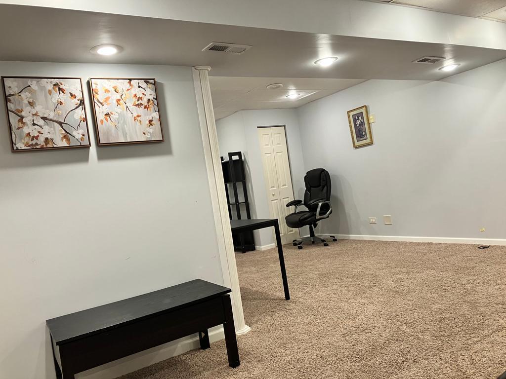 Undisclosed Address Round Lake Beach, IL 60073 - Photo 21 of 28 a room with furniture and paintings on the wall