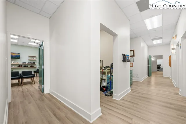 a view of a living room with furniture and wooden floor