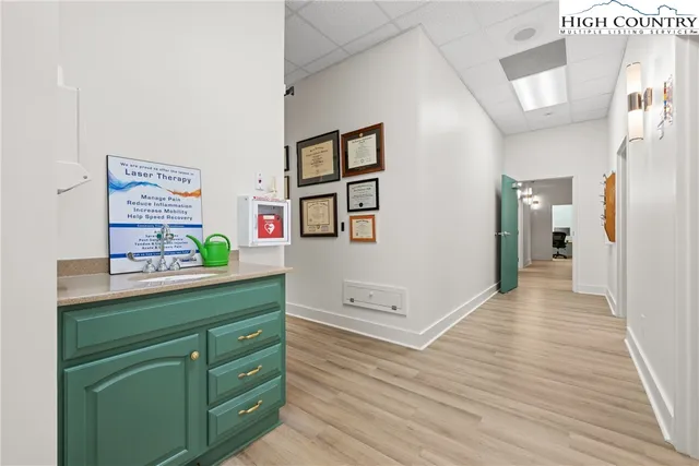 a view of hallway with wooden floor and furniture