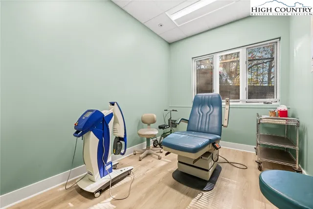 a living room with furniture a window and gym equipment