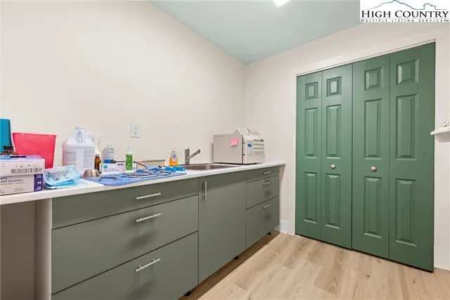 a bathroom with a sink mirror and cabinets