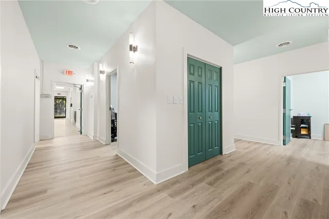 a view of a hallway with wooden floor