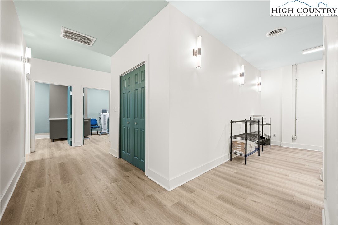 610 State Farm Road, Unit 3 Boone, NC 28607 - Photo 35 of 49 a view of a hallway with wooden floor table and chairs
