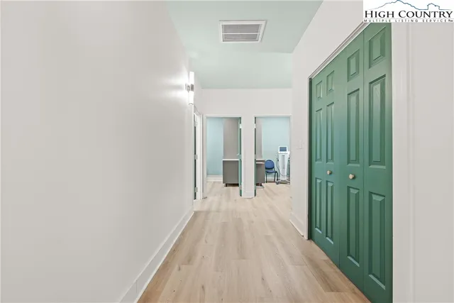 a view of a room with wooden floor