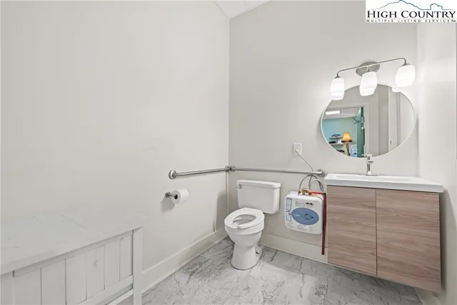 a bathroom with a toilet sink and mirror