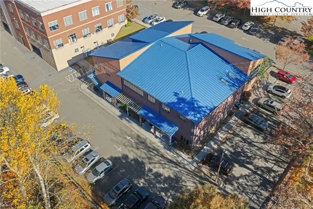 a blue and white umbrella sitting in front of a building