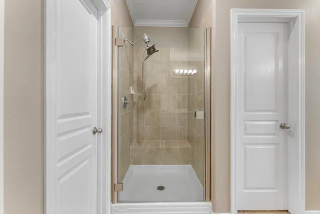 a bathroom with a glass shower door