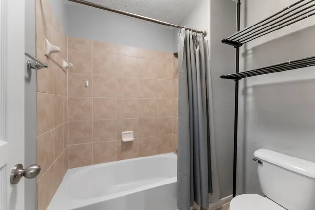a bathroom with a bathtub and a shower