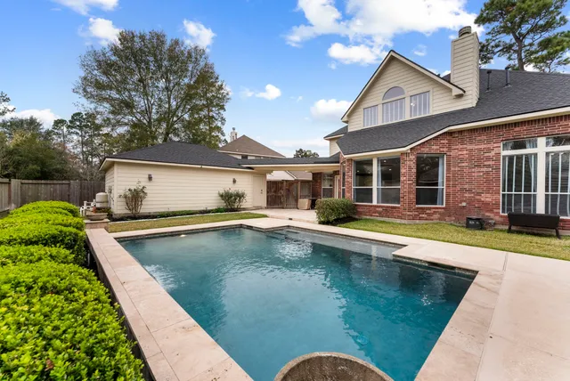 a view of a house with swimming pool and a yard