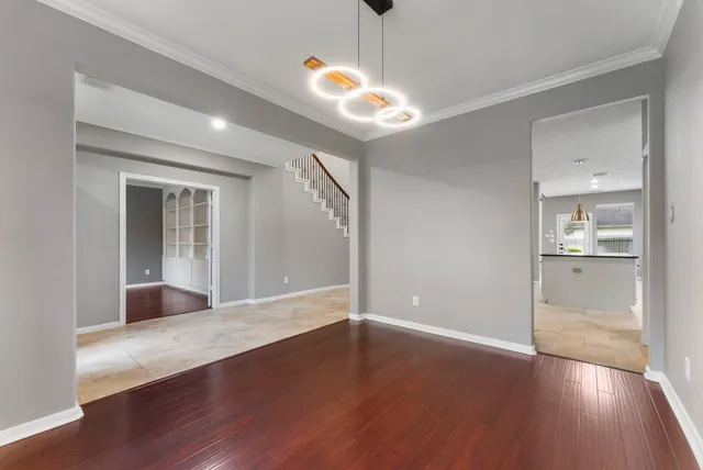 a view of wooden floor and a chandelier in a room