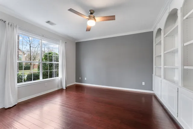 wooden floor in an empty room with a window