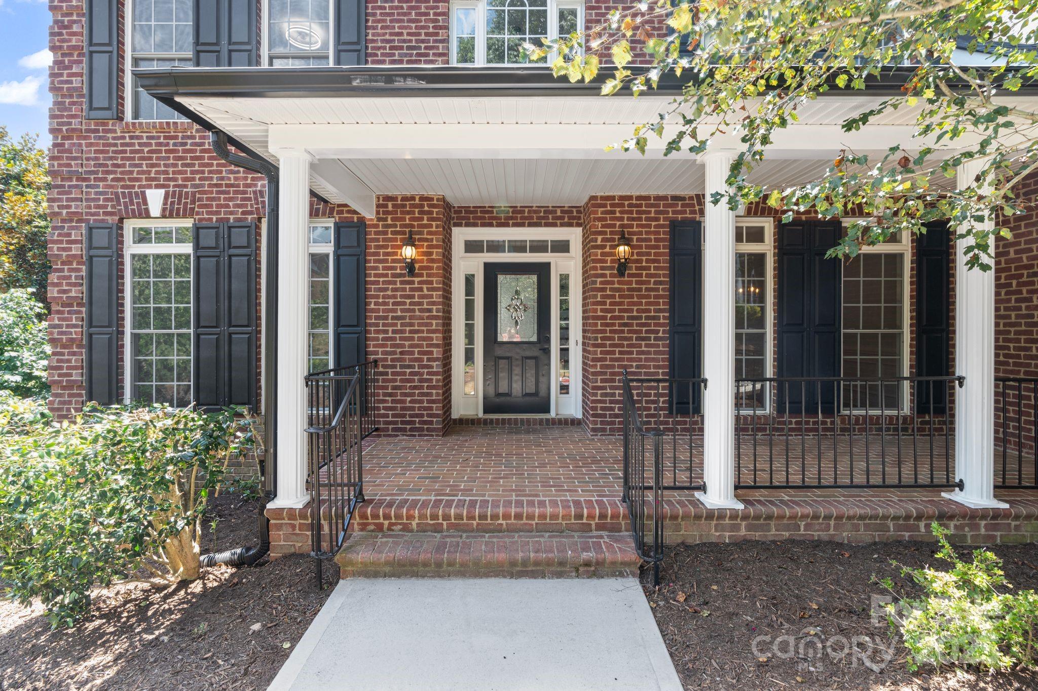 3211 Planters Ridge Road Charlotte, NC 28270 - Photo 3 of 43 front view of a brick house with a small yard