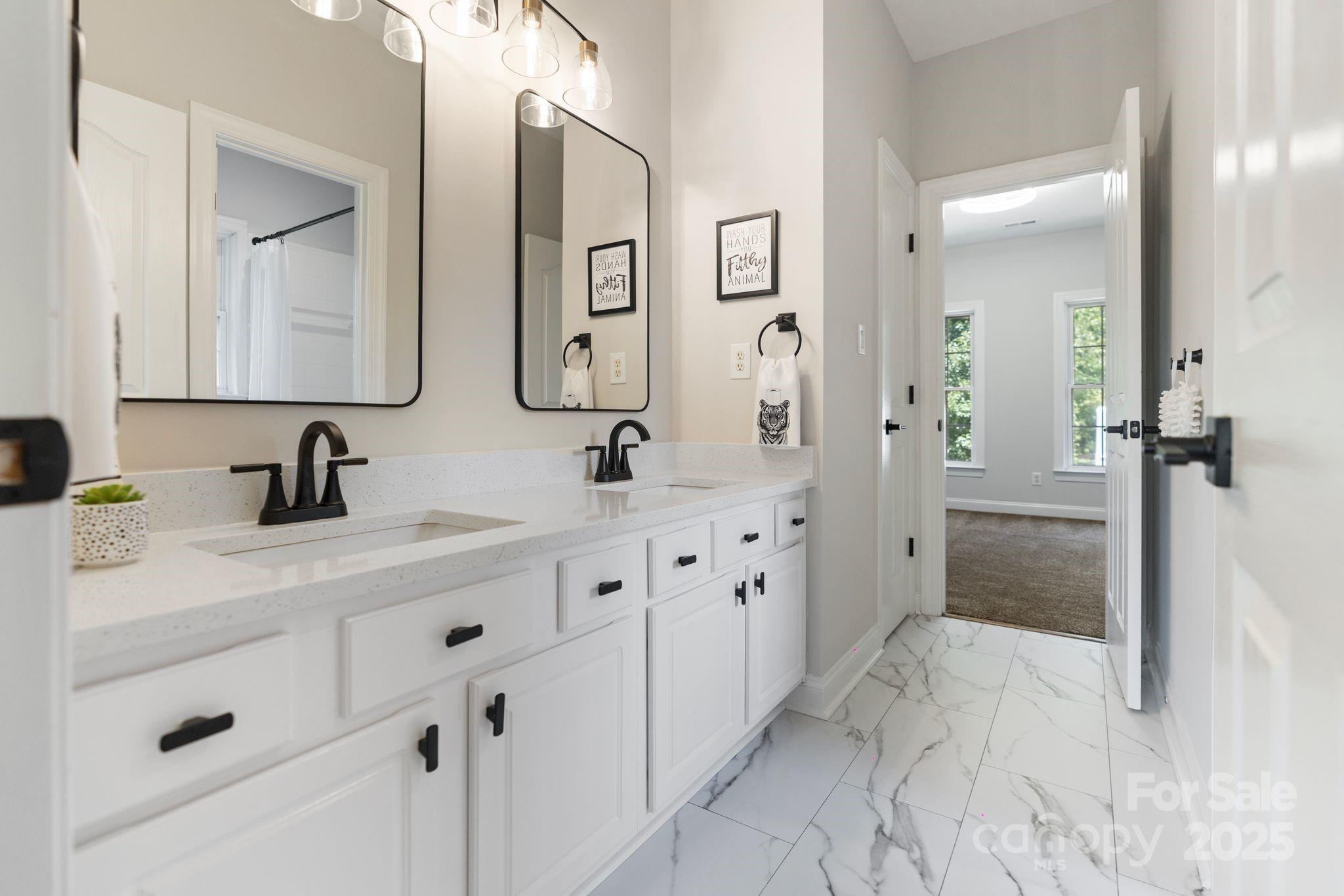 3211 Planters Ridge Road Charlotte, NC 28270 - Photo 31 of 43 a spacious bathroom with double sink and a mirror