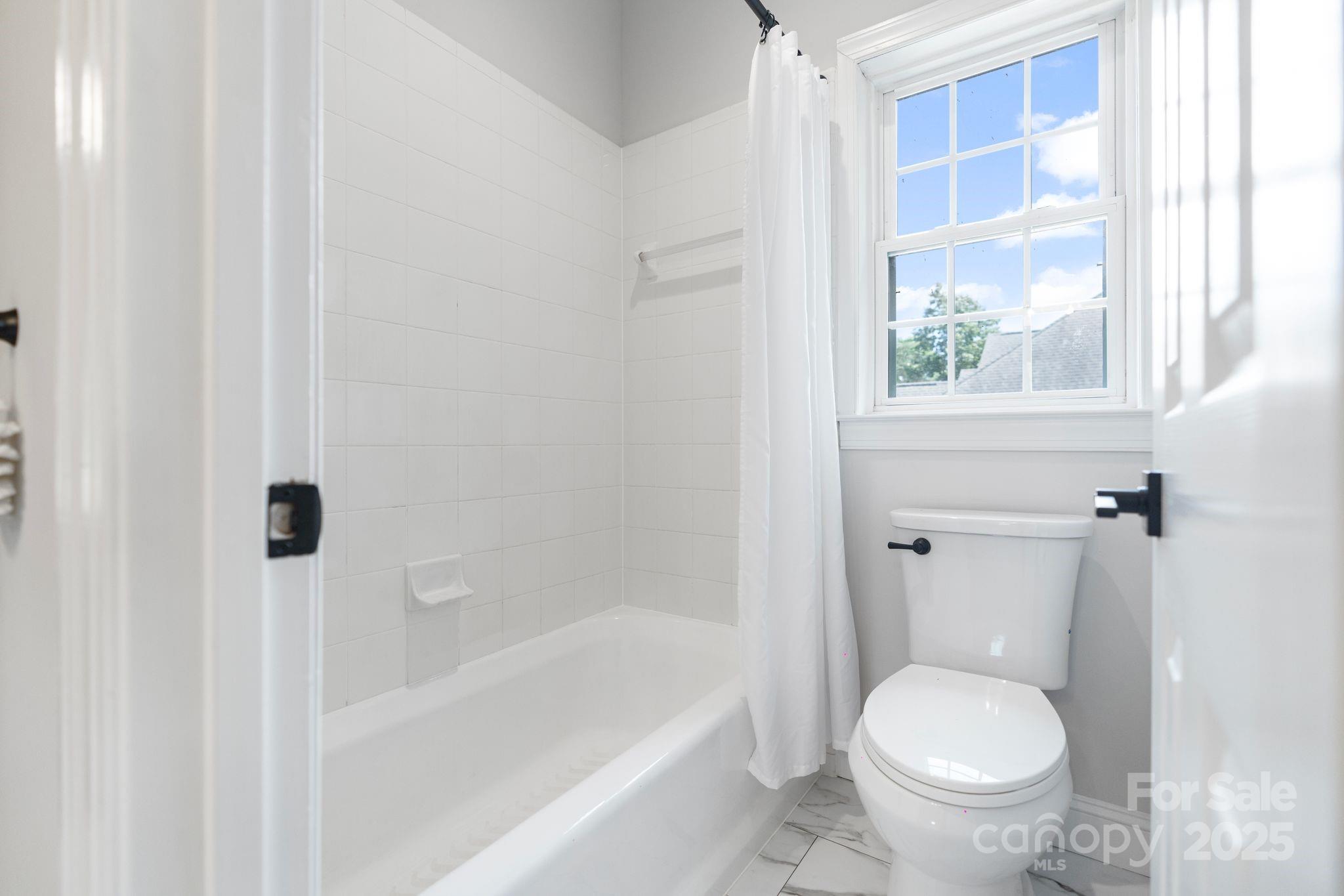 3211 Planters Ridge Road Charlotte, NC 28270 - Photo 34 of 43 a white toilet sitting next to a bath tub