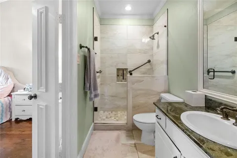 a bathroom with a sink a toilet and shower