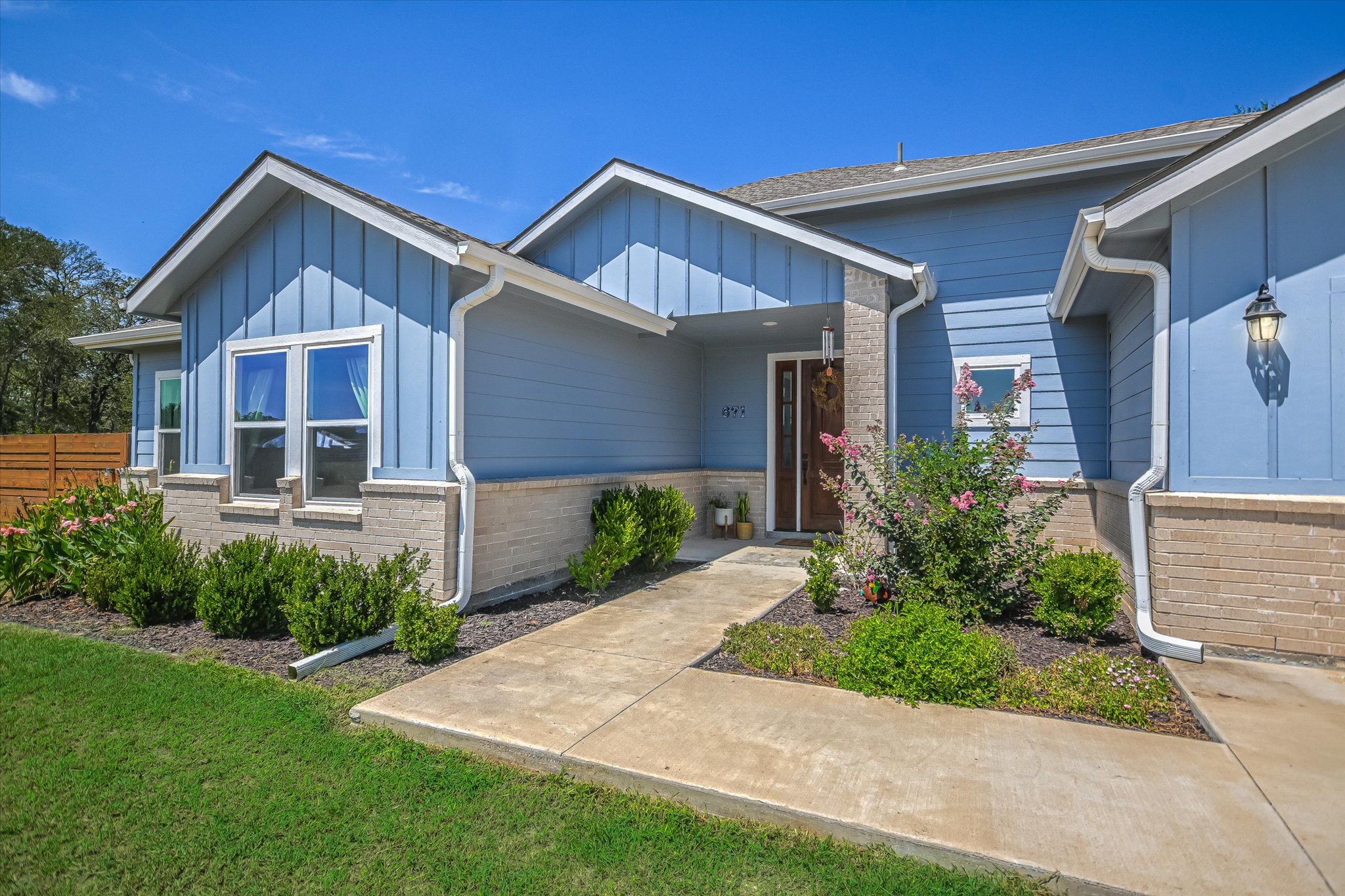 671 Shiloh Road Bastrop, TX 78602 - Photo 2 of 21 Welcoming covered front porch with attractive landscaping and a recessed entry creates great curb appeal.