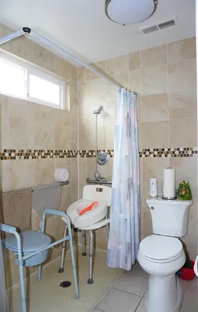 a bathroom with a toilet and a shower