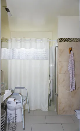 a bathroom with a granite countertop shower and a sink