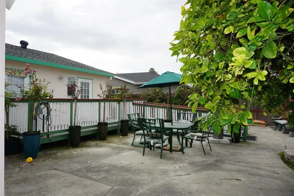 a view of a chairs and tables in the back yard of the house