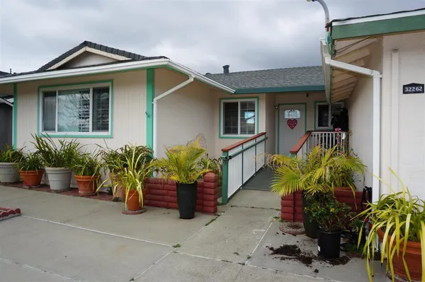 a front view of house with yard outdoor seating space