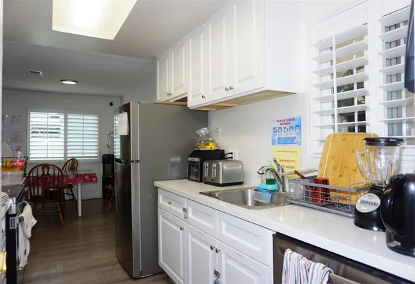 a kitchen with refrigerator and cabinets