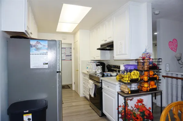 a kitchen with stainless steel appliances granite countertop a refrigerator and a stove