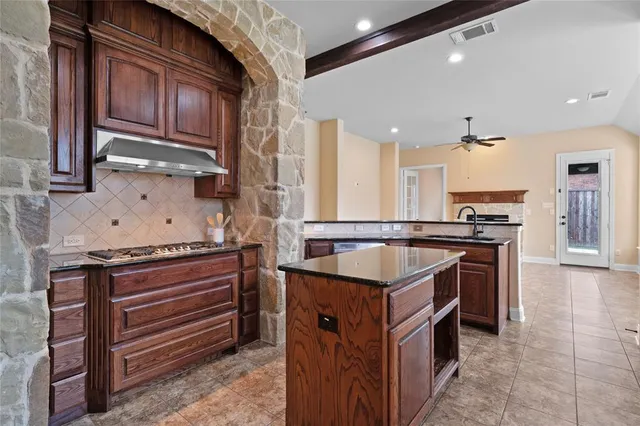 a kitchen with stainless steel appliances granite countertop a stove and a sink