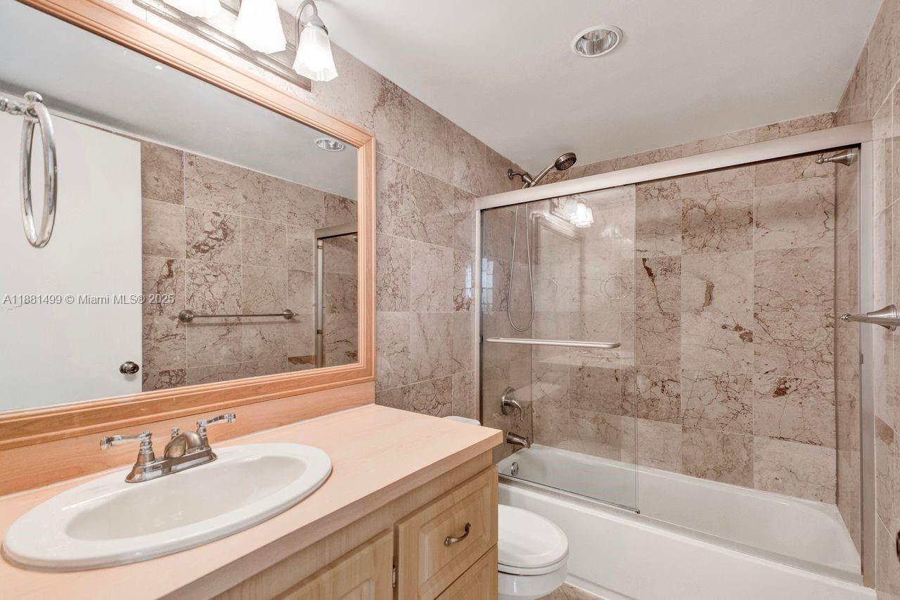 2025 Northeast 164th Street, Unit 716 North Miami Beach, FL 33162 - Photo 19 of 39 a bathroom with a sink and a mirror