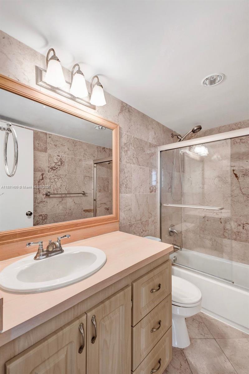 2025 Northeast 164th Street, Unit 716 North Miami Beach, FL 33162 - Photo 20 of 39 a bathroom with a sink a toilet and shower