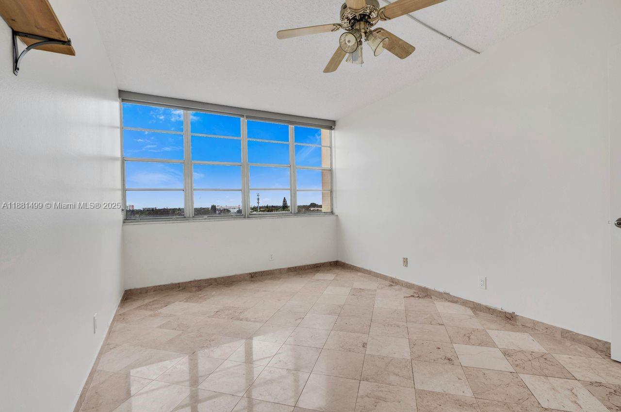 2025 Northeast 164th Street, Unit 716 North Miami Beach, FL 33162 - Photo 23 of 39 a view of an empty room with a window