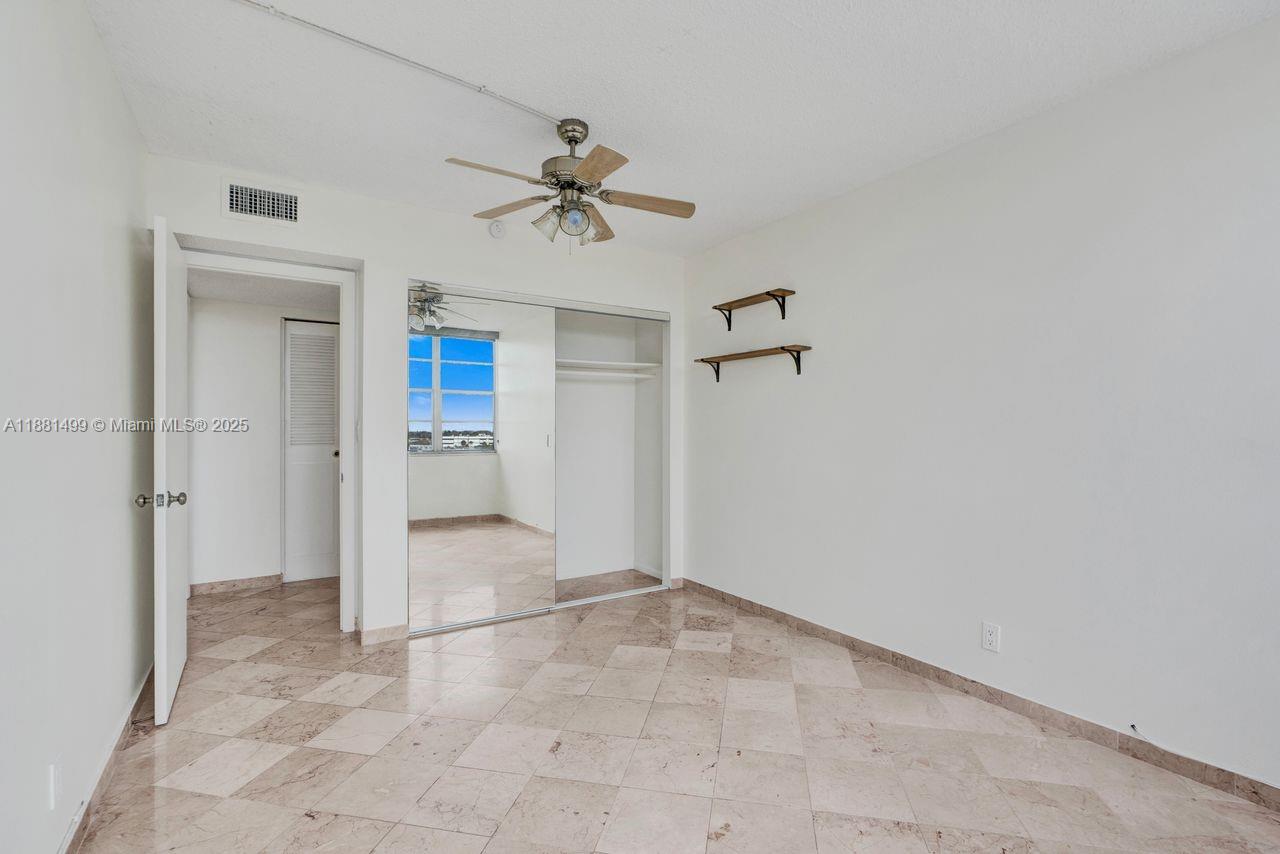 2025 Northeast 164th Street, Unit 716 North Miami Beach, FL 33162 - Photo 25 of 39 a view of empty room with a ceiling fan