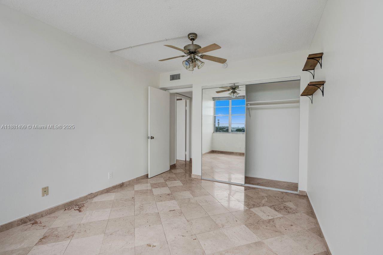 2025 Northeast 164th Street, Unit 716 North Miami Beach, FL 33162 - Photo 26 of 39 a view of a kitchen with a sink and a refrigerator