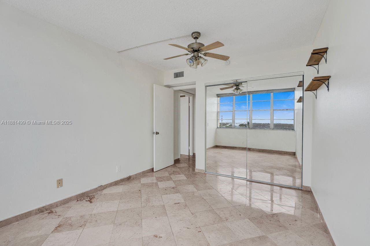 2025 Northeast 164th Street, Unit 716 North Miami Beach, FL 33162 - Photo 27 of 39 a view of a kitchen with a sink and a refrigerator