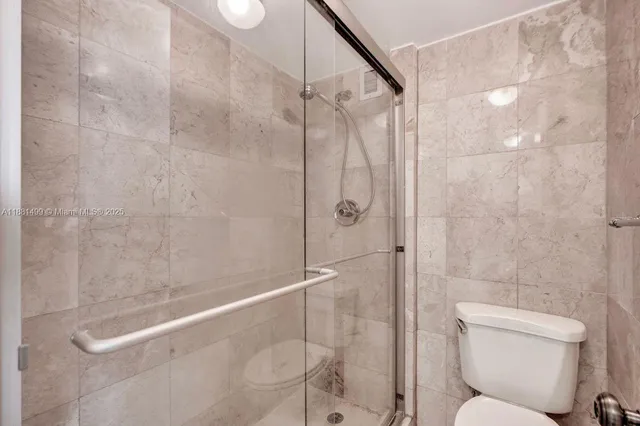a bathroom with a shower and a toilet