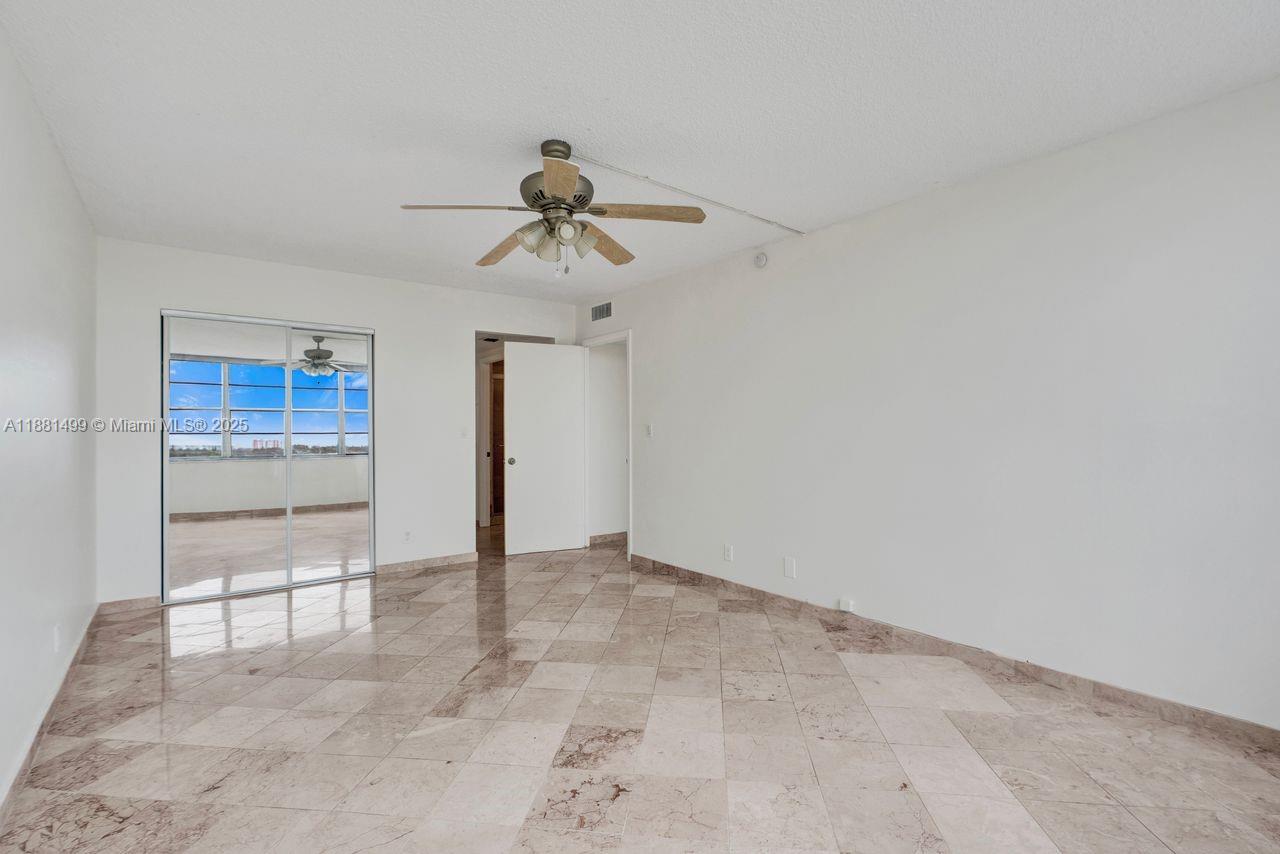 2025 Northeast 164th Street, Unit 716 North Miami Beach, FL 33162 - Photo 35 of 39 wooden floor in an empty room
