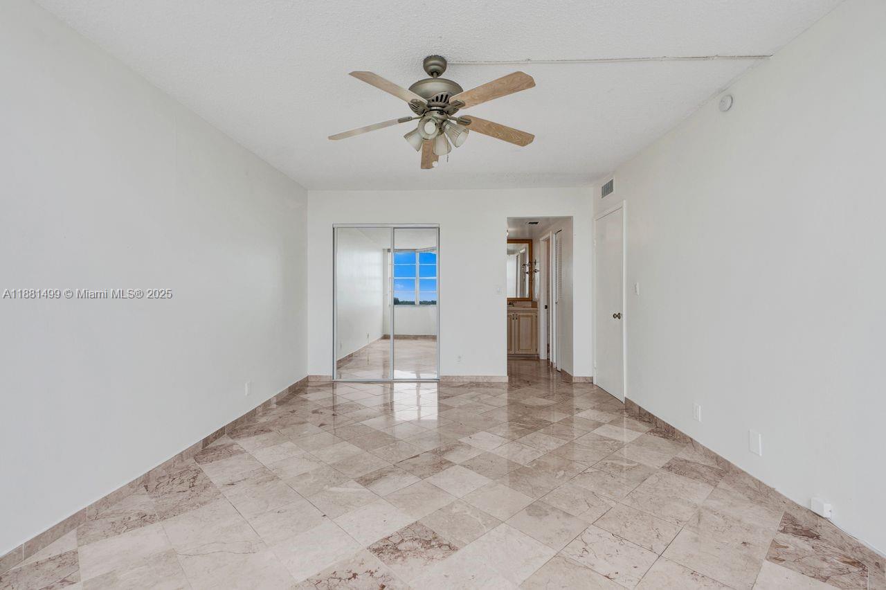 2025 Northeast 164th Street, Unit 716 North Miami Beach, FL 33162 - Photo 37 of 39 a view of an empty room with a ceiling fan