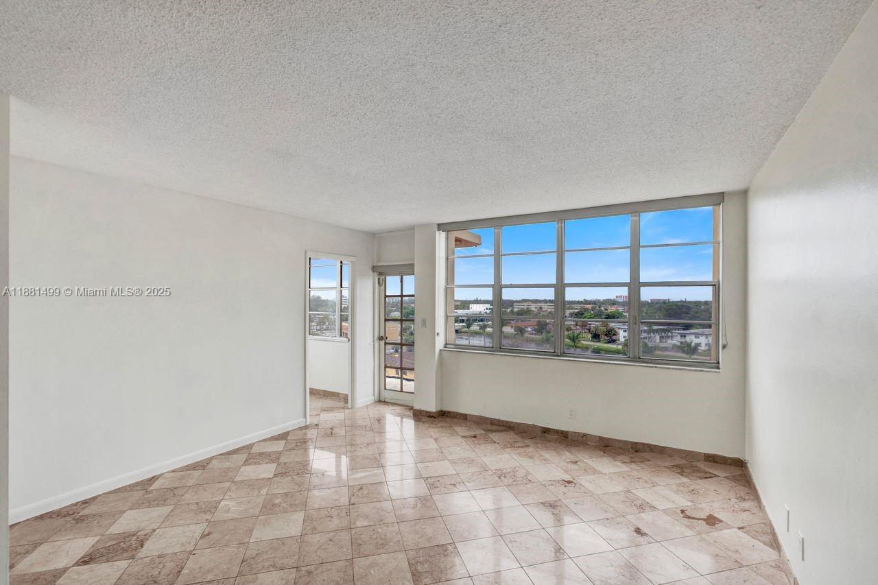 2025 Northeast 164th Street, Unit 716 North Miami Beach, FL 33162 - Photo 8 of 39 a view of a kitchen with a sink and a window
