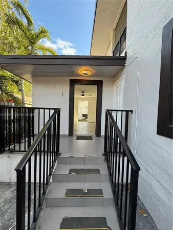 a view of a porch with wooden floor and stairs