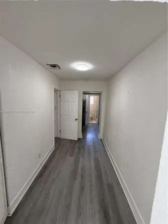a view of wooden floor and windows in a room