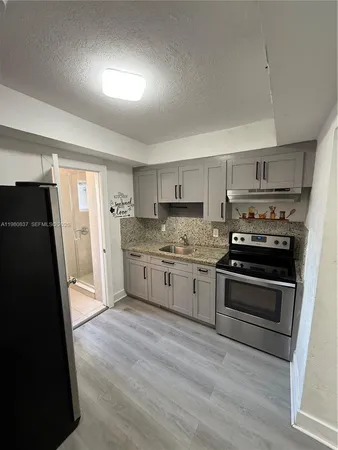 a kitchen with a refrigerator stove and sink